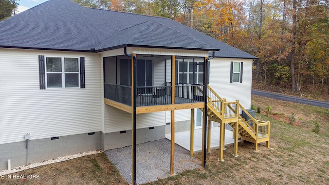 back of property with ceiling fan, a sunroom, and a patio area