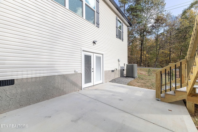 view of side of property featuring a patio area and cooling unit