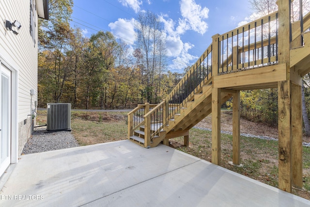 view of patio / terrace with central AC unit and a wooden deck