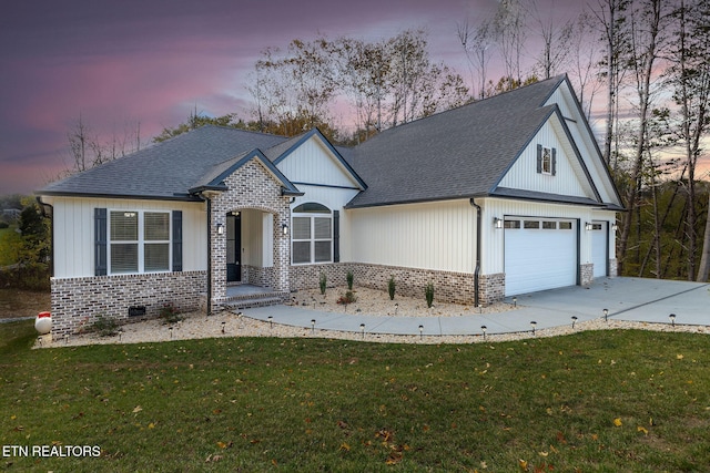 view of front facade featuring a garage and a lawn