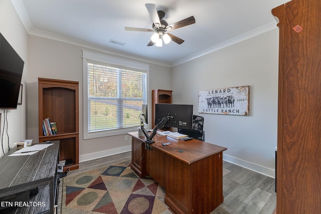 office area with ornamental molding, dark wood-type flooring, and ceiling fan