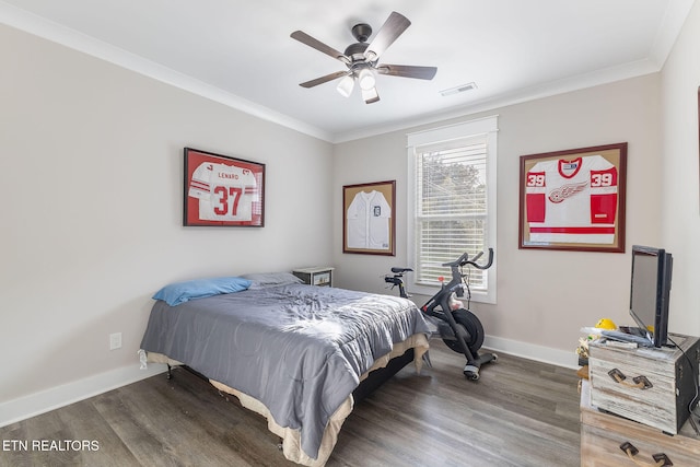 bedroom with hardwood / wood-style flooring, ceiling fan, and crown molding