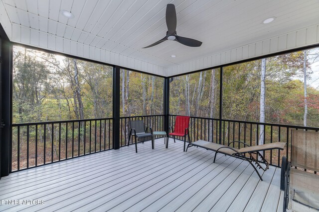 unfurnished sunroom featuring ceiling fan