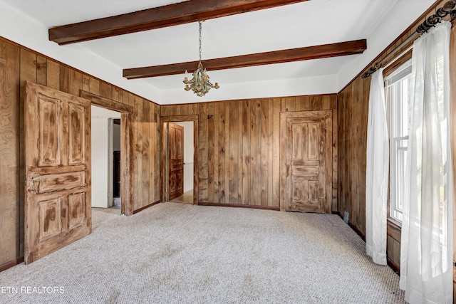 unfurnished bedroom featuring a notable chandelier, wooden walls, light carpet, and beam ceiling