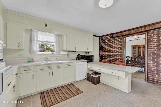 kitchen featuring kitchen peninsula, sink, white dishwasher, and brick wall