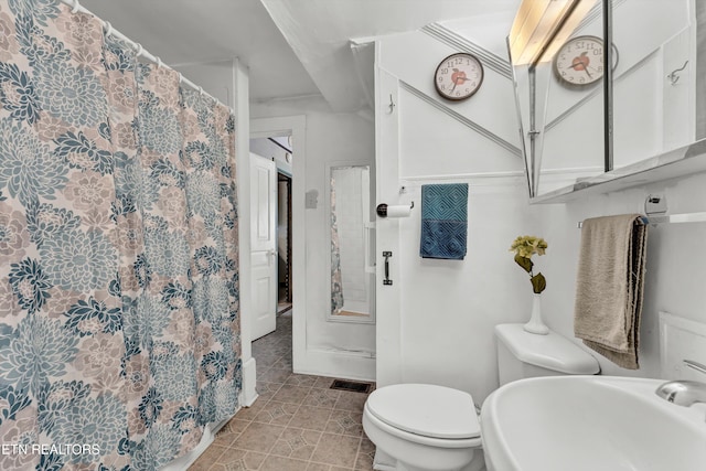 bathroom with tile patterned flooring, sink, and toilet