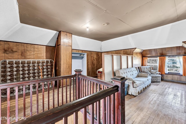 interior space with wood walls, lofted ceiling, and wood-type flooring