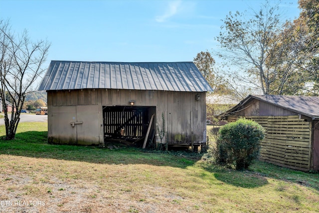 view of outbuilding featuring a yard