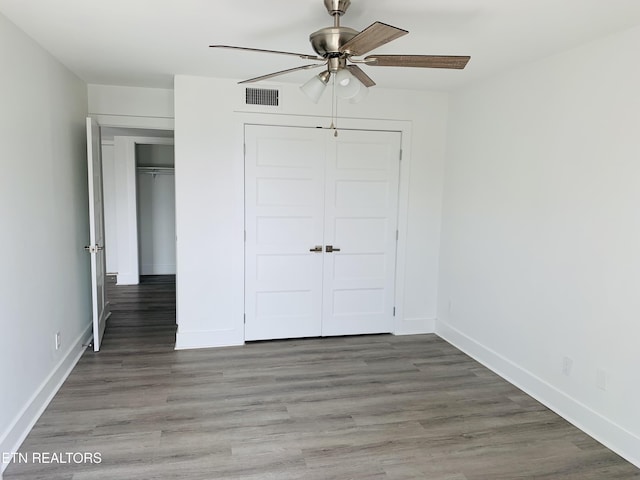 5709 Lyons View Pike Unit 4202, Knoxville, TN 37919 - unfurnished bedroom featuring baseboards, wood finished floors, a closet, and a ceiling fan