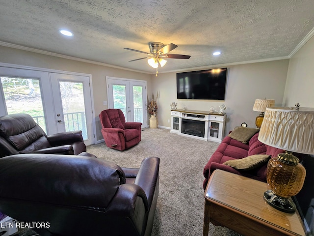 living room featuring carpet, french doors, ceiling fan, and a textured ceiling