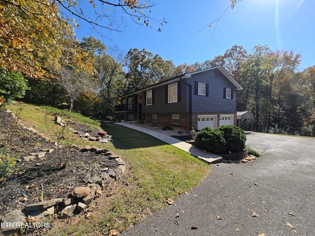 view of home's exterior featuring a garage and a yard