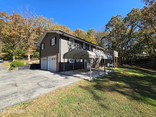 view of front of home featuring a front yard, a carport, and a garage