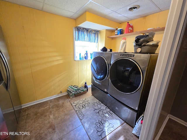 laundry area featuring tile patterned flooring and washer and clothes dryer