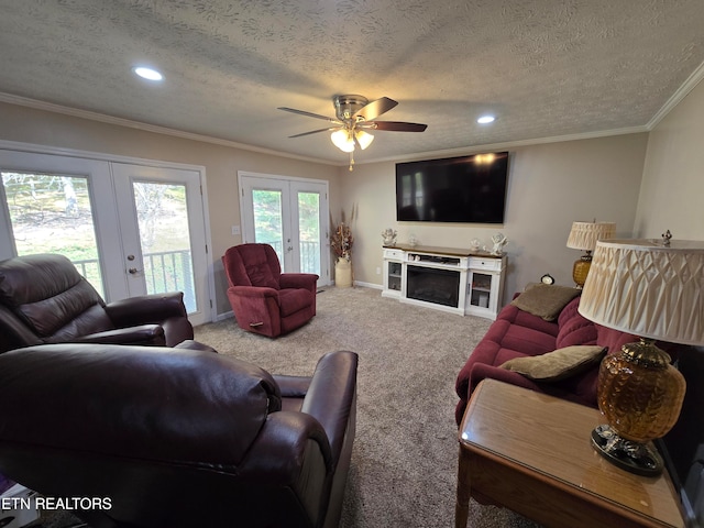 living room with french doors, carpet floors, a textured ceiling, and ceiling fan