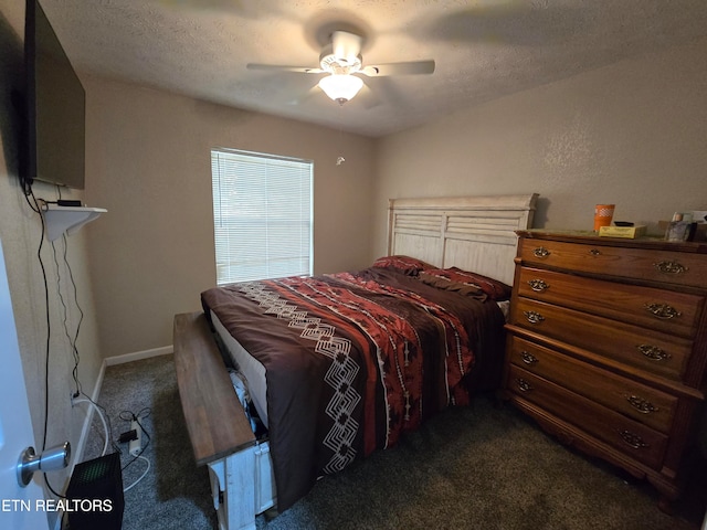 carpeted bedroom featuring ceiling fan and a textured ceiling