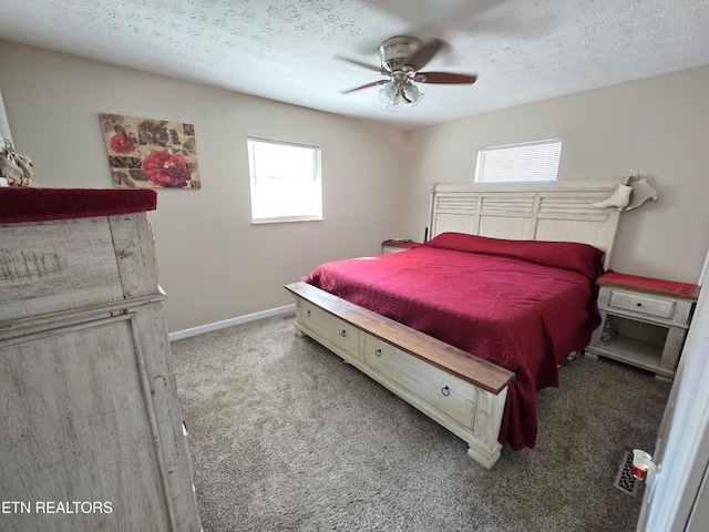 bedroom featuring a textured ceiling, carpet, multiple windows, and ceiling fan