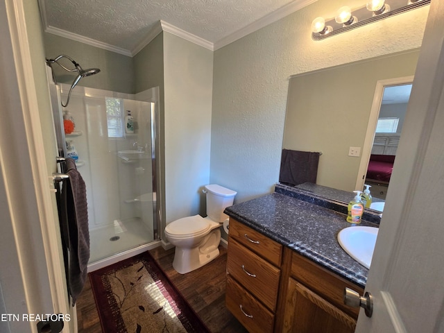 bathroom featuring hardwood / wood-style flooring, walk in shower, ornamental molding, a textured ceiling, and vanity