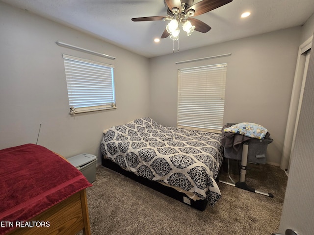 bedroom with ceiling fan and dark carpet