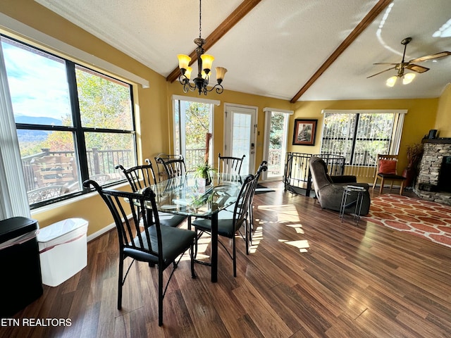 dining space with dark wood-type flooring, a textured ceiling, and vaulted ceiling with beams