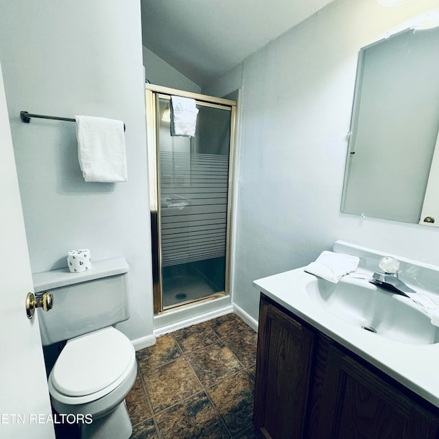 bathroom with a shower with door, vanity, toilet, and vaulted ceiling