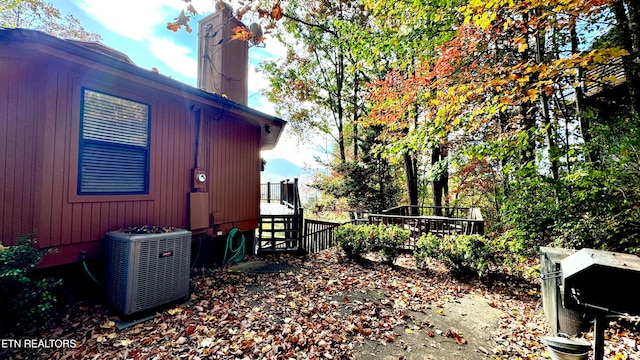 view of side of home featuring cooling unit and a deck