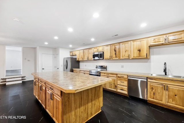 kitchen with sink, a kitchen island, and appliances with stainless steel finishes