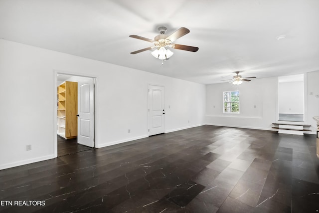 spare room with ceiling fan and dark hardwood / wood-style floors