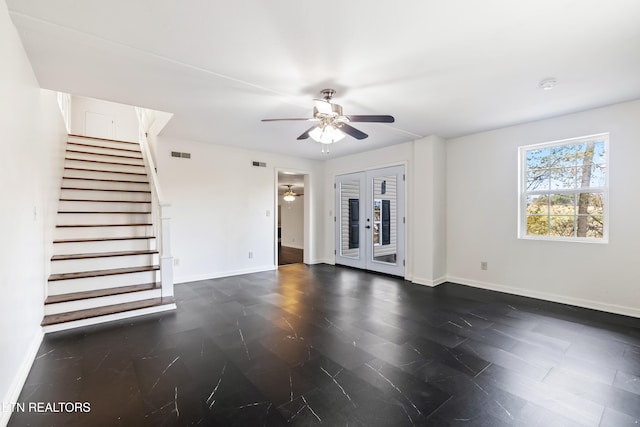 unfurnished living room featuring french doors and ceiling fan