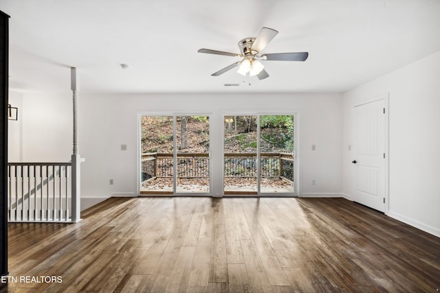 spare room with dark wood-type flooring and ceiling fan