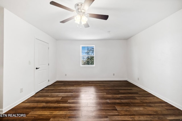 spare room featuring dark hardwood / wood-style flooring and ceiling fan