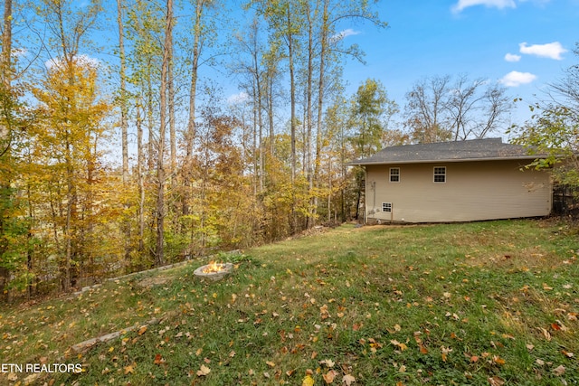 view of yard with a fire pit