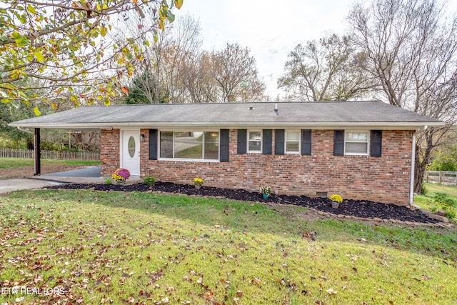 single story home with a front lawn and a carport