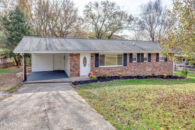 ranch-style house featuring a front yard and a carport