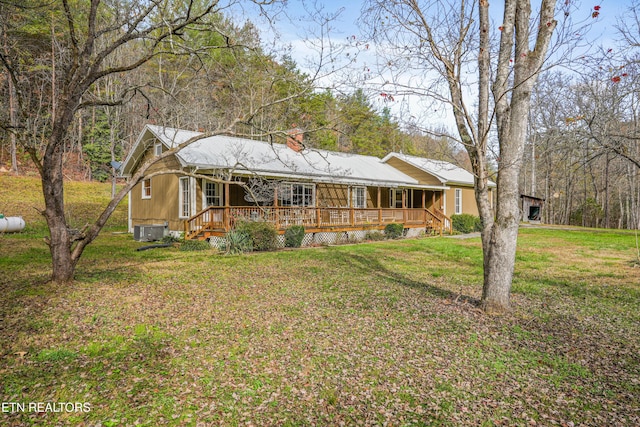 back of house with a yard and a deck