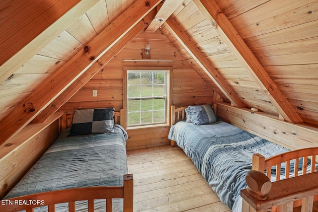 bedroom featuring vaulted ceiling with beams, light hardwood / wood-style flooring, wooden ceiling, and wood walls