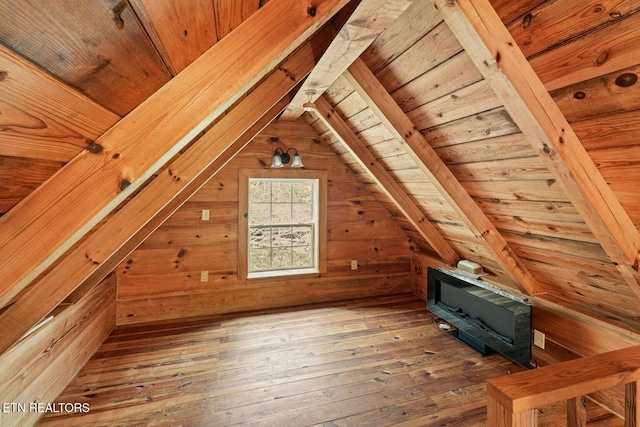 bonus room featuring vaulted ceiling, hardwood / wood-style floors, wooden ceiling, and wood walls