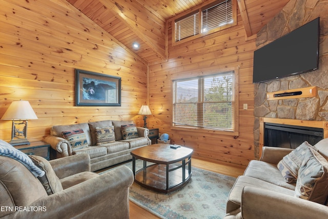 living room with wood-type flooring, a fireplace, high vaulted ceiling, wood walls, and wood ceiling