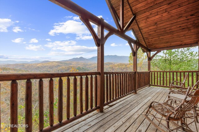 wooden deck with a mountain view