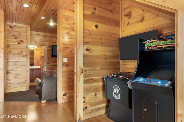 interior space with hardwood / wood-style floors, wood walls, and wood ceiling