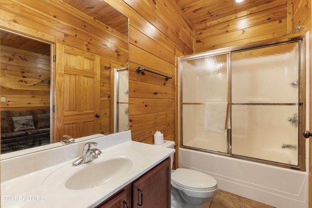 full bathroom featuring vanity, wood walls, bath / shower combo with glass door, tile patterned flooring, and wooden ceiling