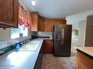 kitchen featuring stainless steel fridge and sink