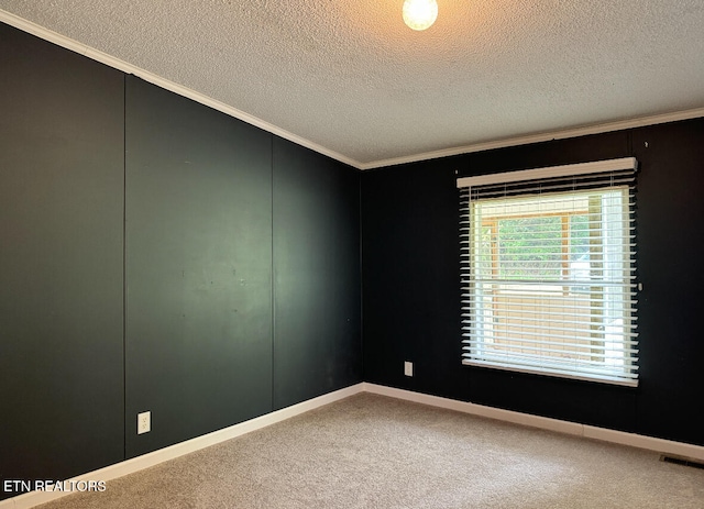 carpeted empty room with a textured ceiling and ornamental molding