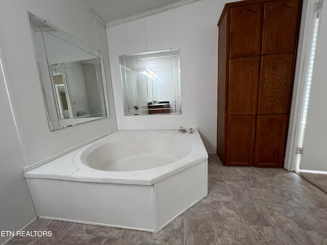 bathroom with a tub to relax in and ornamental molding