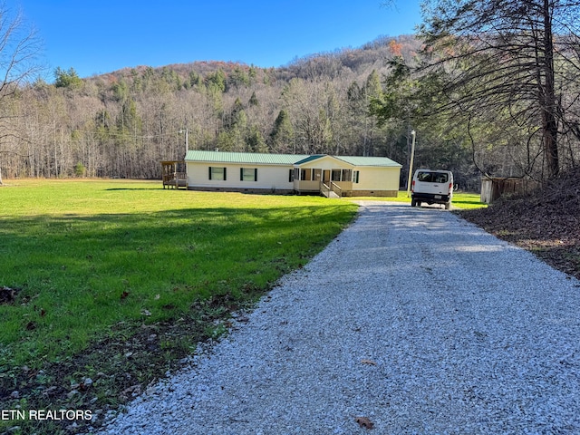 view of front facade with a front yard and a mountain view