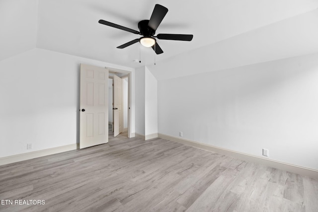 interior space featuring ceiling fan, light wood-type flooring, and vaulted ceiling