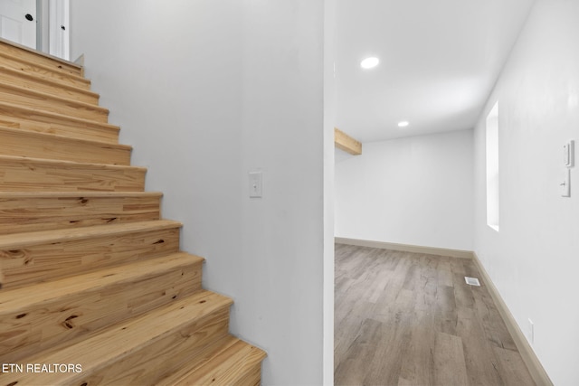 stairway featuring hardwood / wood-style flooring