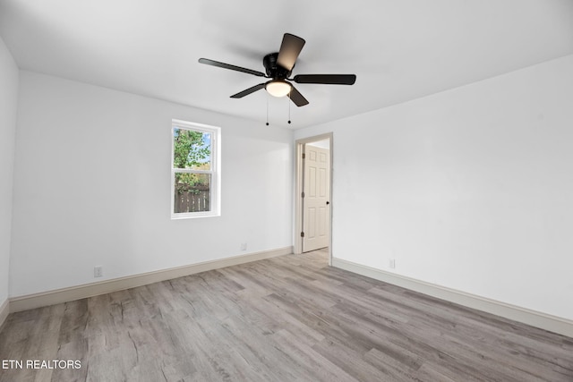 spare room featuring light wood-type flooring and ceiling fan