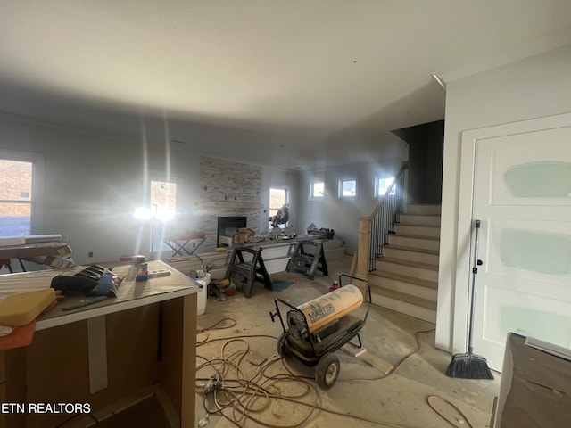 basement with a healthy amount of sunlight and a fireplace