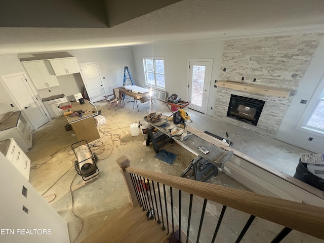 unfurnished living room featuring a stone fireplace