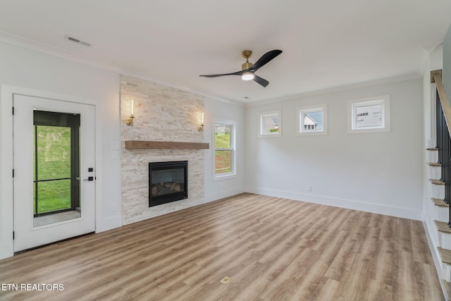 2210 Hickory Crest Ln, Knoxville, TN 37932 - unfurnished living room featuring ornamental molding, a fireplace, ceiling fan, light wood-style floors, and stairs